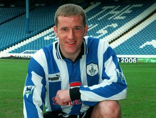 Sheffield Wednesday's Peter Atherton pictured, crouching, on the pitch at Hillsborough, 1998