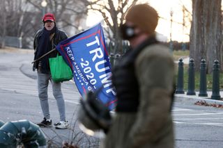 A lone Trump supporter holds a flag outside the U.S. Capitol Jan. 7, 2021 in Washington, DC. 