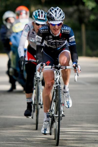 A Saxo Bank rider and an Omega Pharma - Lotto rider try their luck before they reach the top of the last mountain.