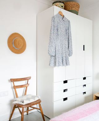 white bedroom with wardrobe and chair