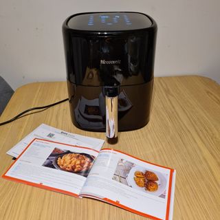 Proscenic T22 Air Fryer with recipe book on wooden table