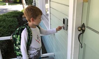 Child pressing the doorbell