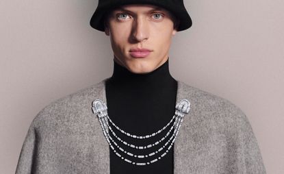 model wears Boucheron diamond jewellery clipped to cardigan 
