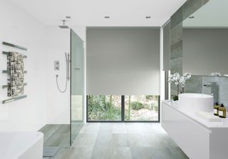 a modern bathroom with a large grey blind
