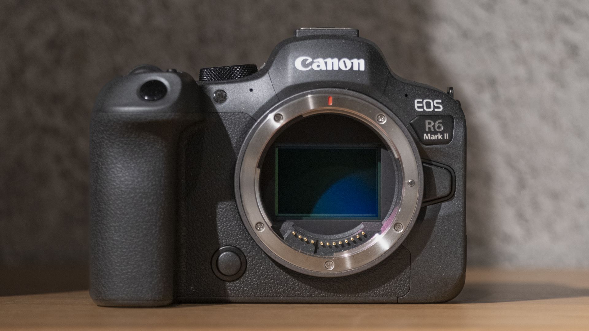 The Canon EOS R6 Mark II camera on a wooden shelf