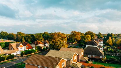 An aerial view of suburban houses and gardens.