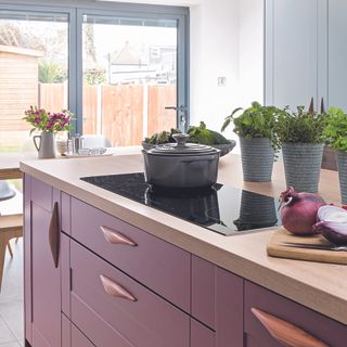 Burgundy kitchen island with oak worktop