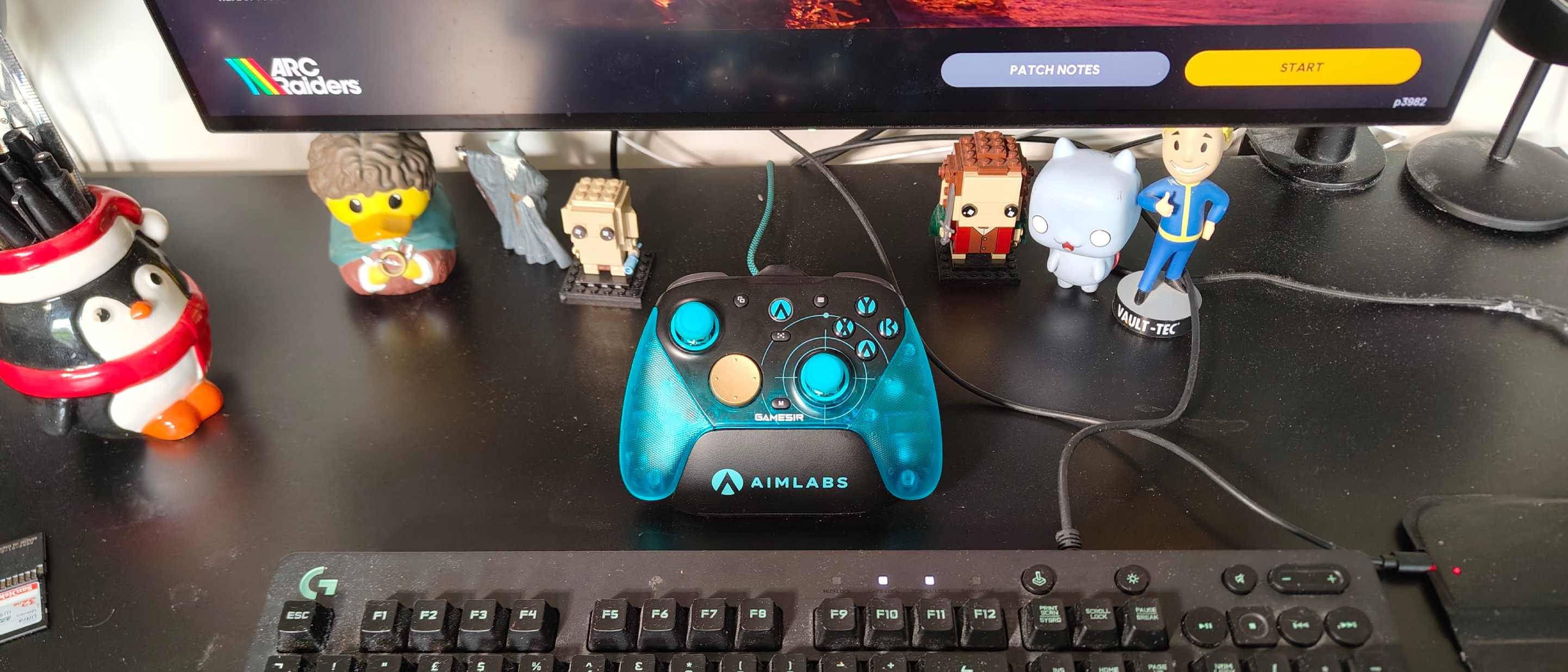 The GameSir G7 Pro 8k on a black desk, surrounded by models.