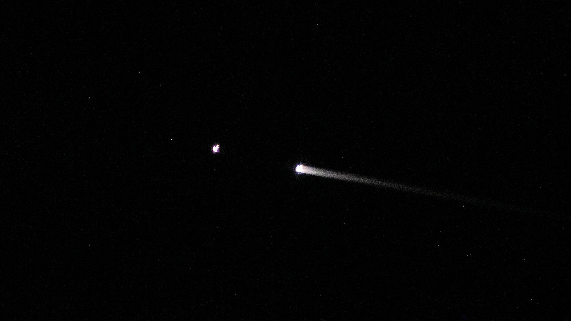 A streak of white zooms across the black background