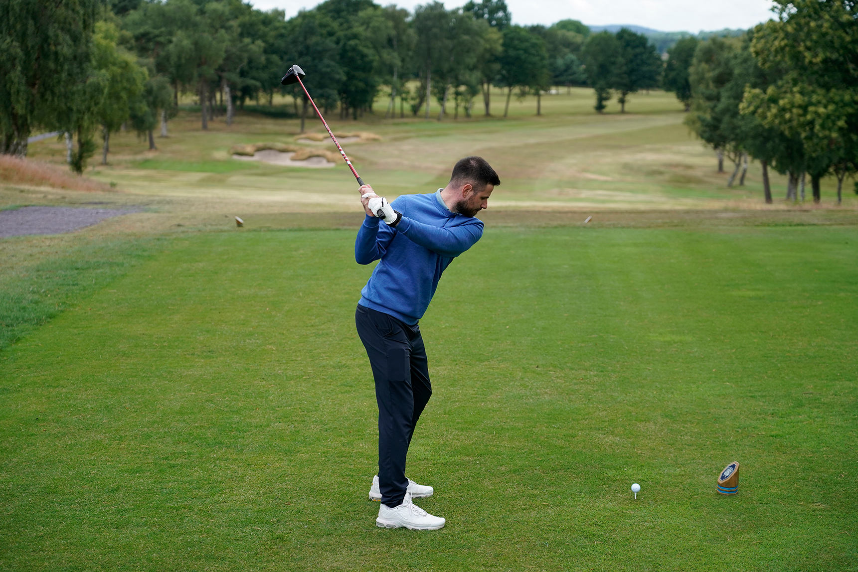 Baz Plummer at the top of his backswing with driver, on the tee box at the 6th hole at Sand Moor Golf Club