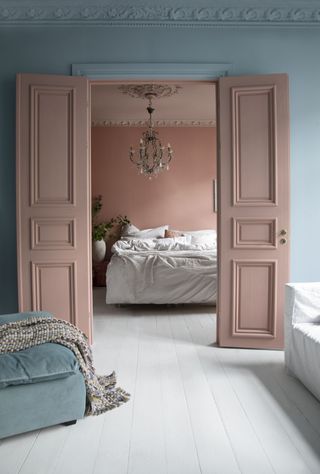 A bedroom with a light and deep tone of pink