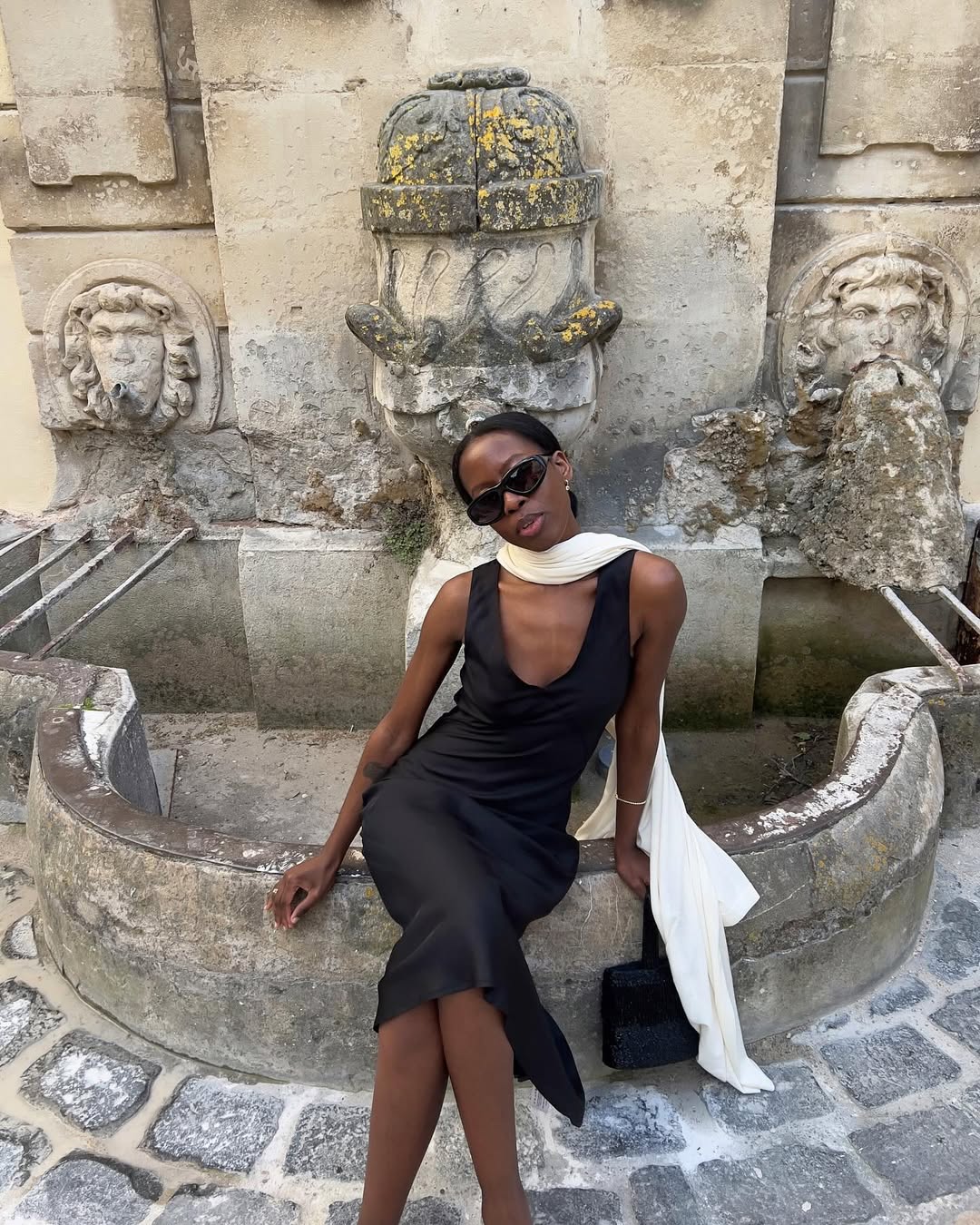 Sylvie in a black dress and white silk scarf