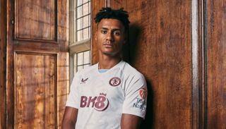 Ollie Watkins models the Aston Villa away shirt