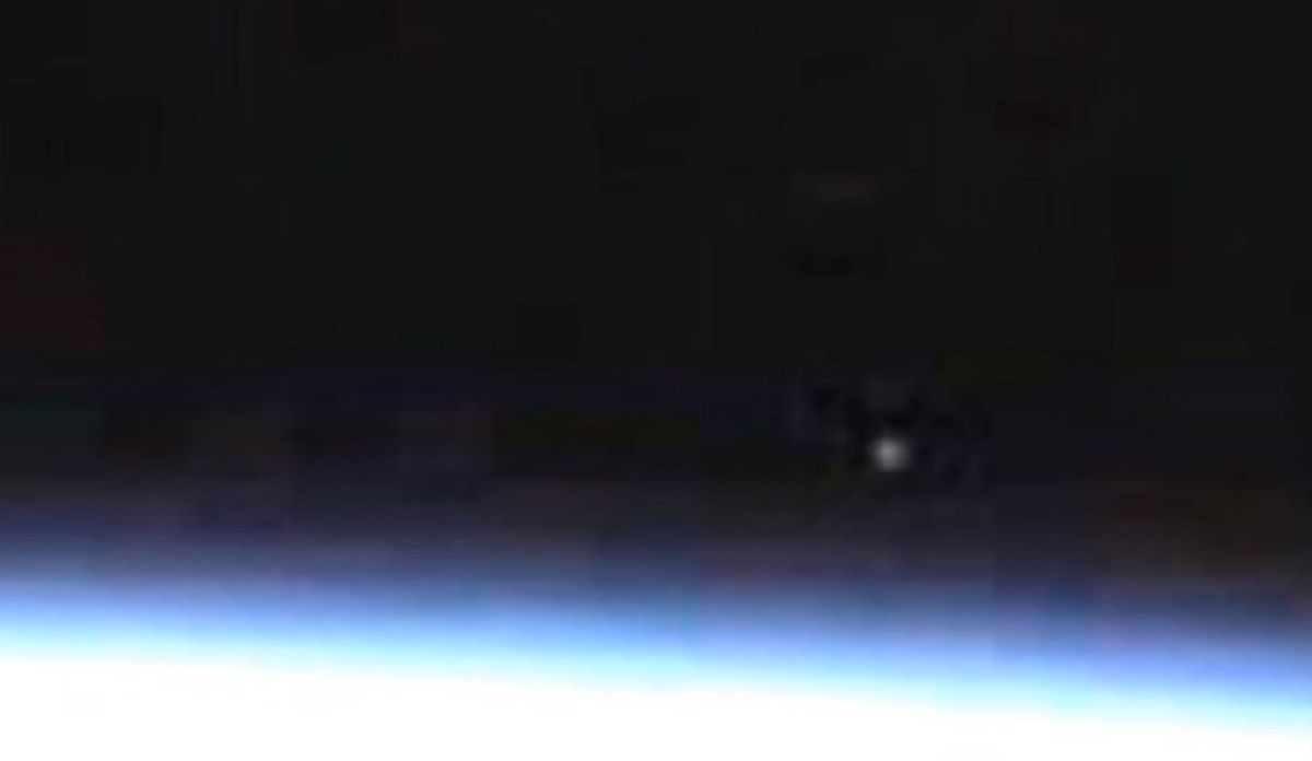 A bright spot appears in a video from the live camera on the International Space Station.