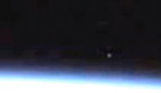 A bright spot appears in a video from the live camera on the International Space Station.
