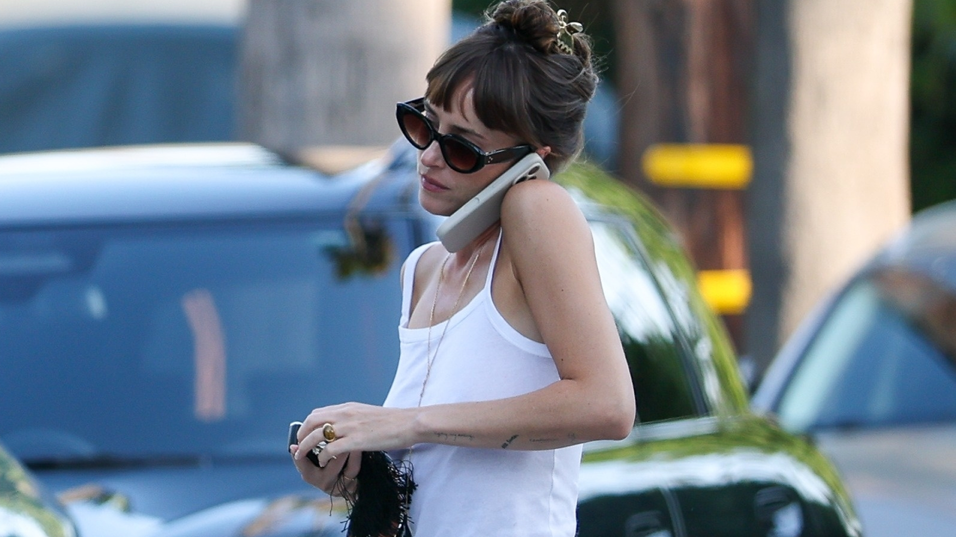 Dakota Johnson styled a white tank top with straight-leg jeans and the high-vamp flats trend
