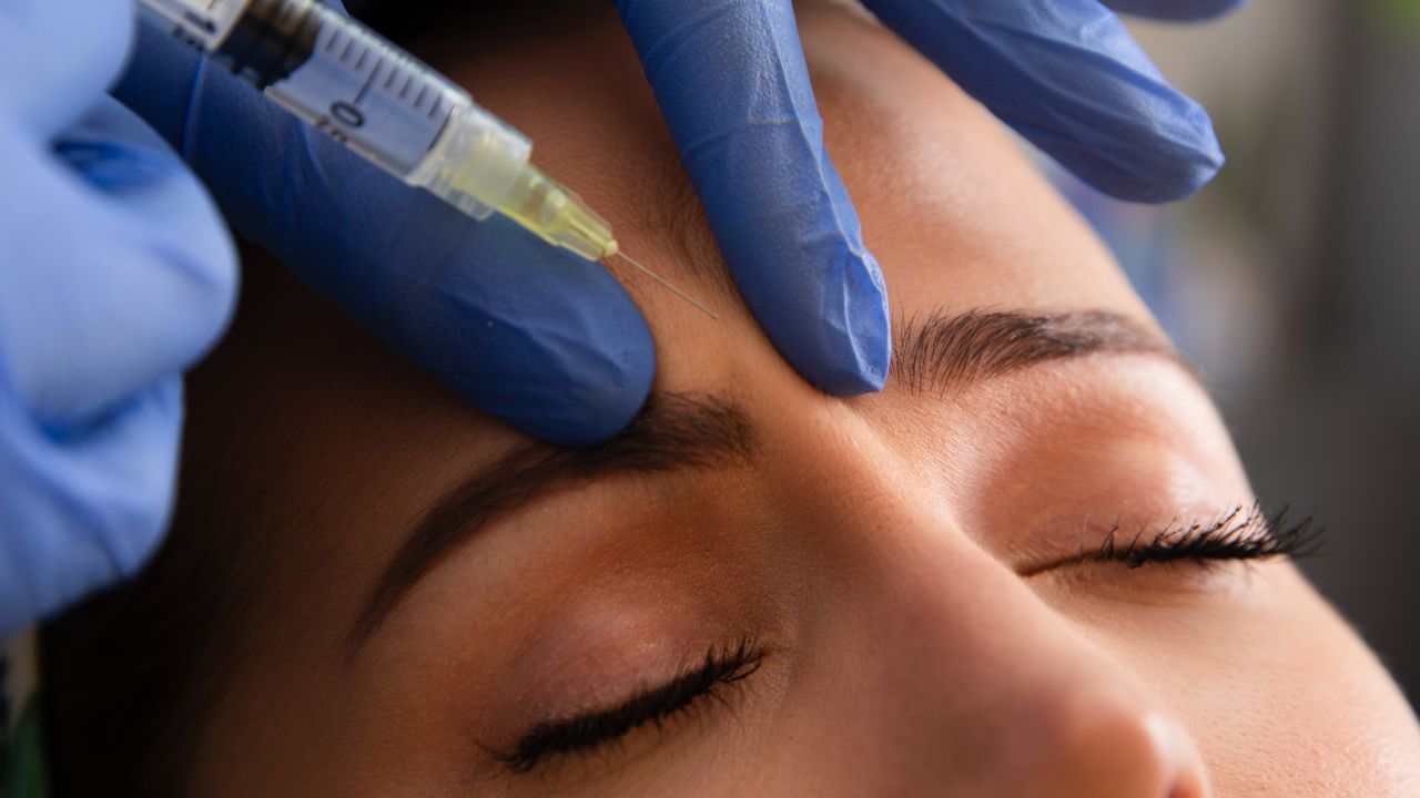 Young woman getting Botox injection