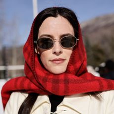 Riley Keough wears a red scarf around her head