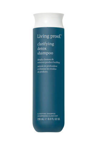 A bottle of Living proof clarifying detox shampoo set against a white background.