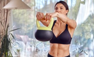 a photo of a woman doing a kettlebell raise