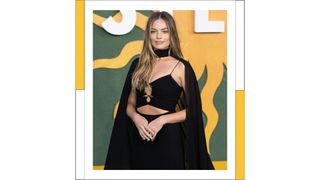 Margot Robbie wears a black cut out dress as she attends the "Amsterdam" European Premiere at Odeon Luxe Leicester Square on September 21, 2022 in London, England
