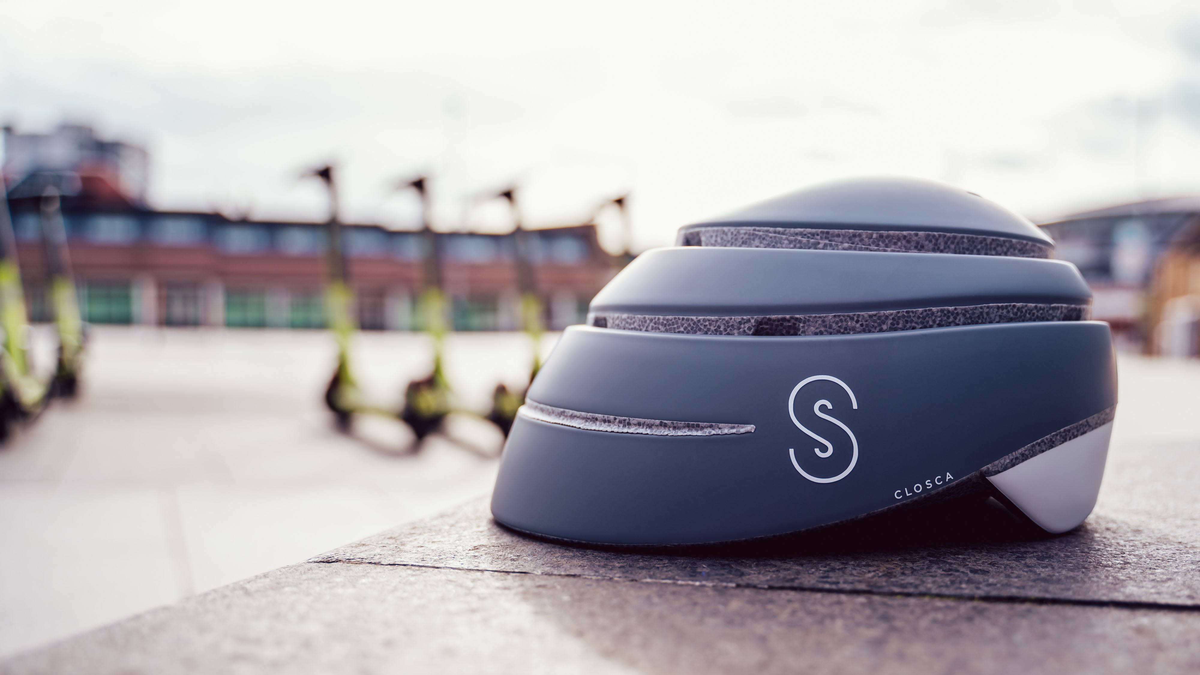 Foldable safety helmet with e-scooters in the background