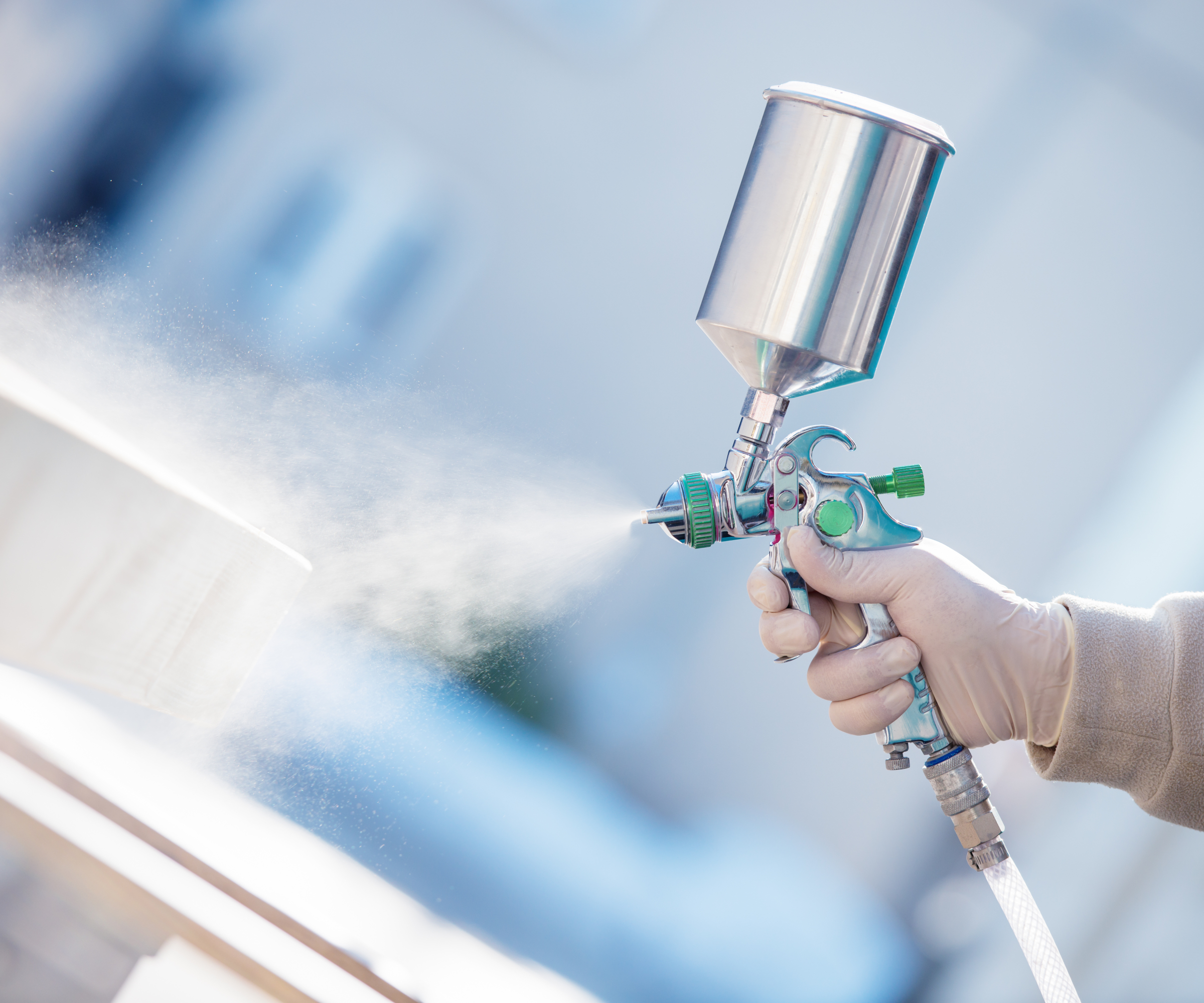 hand holding silver spraying unit