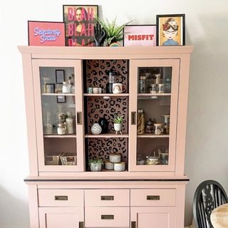 pink dresser with glass door and drawers