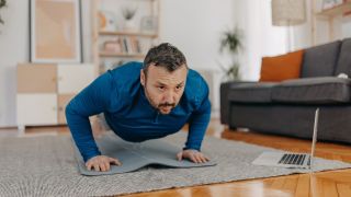 Man performing push up at home