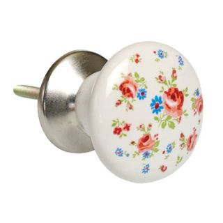 A white ceramic door knob with colourful floral prints on the handle.