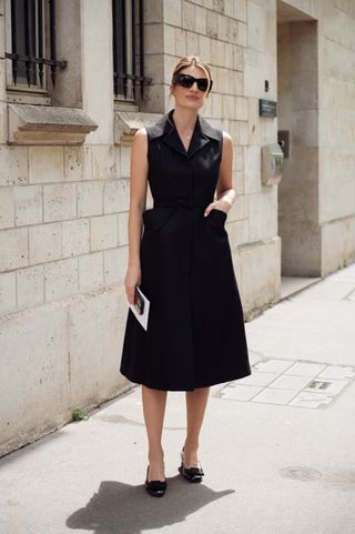 woman wearing minimal black midi dress