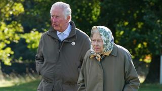 Queen Elizabeth II and Prince Charles, Prince of Wales (known as the Duke of Rothesay when in Scotland) walk to the Balmoral Estate Cricket Pavilion