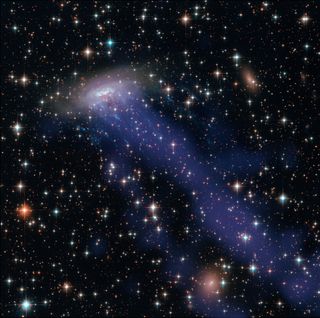 Swimming through a group of galaxies more than 200 million light-years away from Earth is the so-called "jellyfish" galaxy named ESO 137-001. This celestial jellyfish is a spiral galaxy much like the Milky Way, but it has long "tentacles" of hot gas streaming away from the galactic disk. Scientists aren't sure how the gas is being stripped away, but NASA's James Webb Space Telescope may be able to shed some light on the origin of those tentacles by studying them in unprecedented detail after its planned launch in 2021. This view combines visible-light imagery from the Hubble Space Telescope and X-ray data from the Chandra X-ray Observatory.