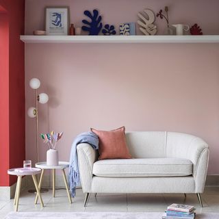 room with pink wall and white sofa