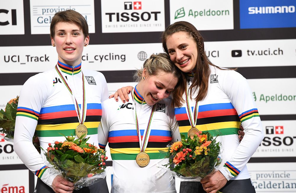 Germany's gold medallists Miriam Welte, Kristina Vogel and Pauline Sophie Grabosch celebrate on the podium after victory in the women's team sprint final race at The UCI World Cycling Championships