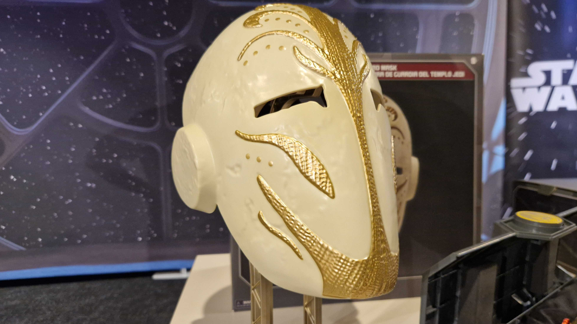 Star Wars Jedi Temple Guard Ceremonial Mask on a stand, against a starry background