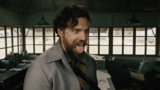 henry cavill sticks out his tongue, in still from 'the ministry of ungentlemanly warfare'