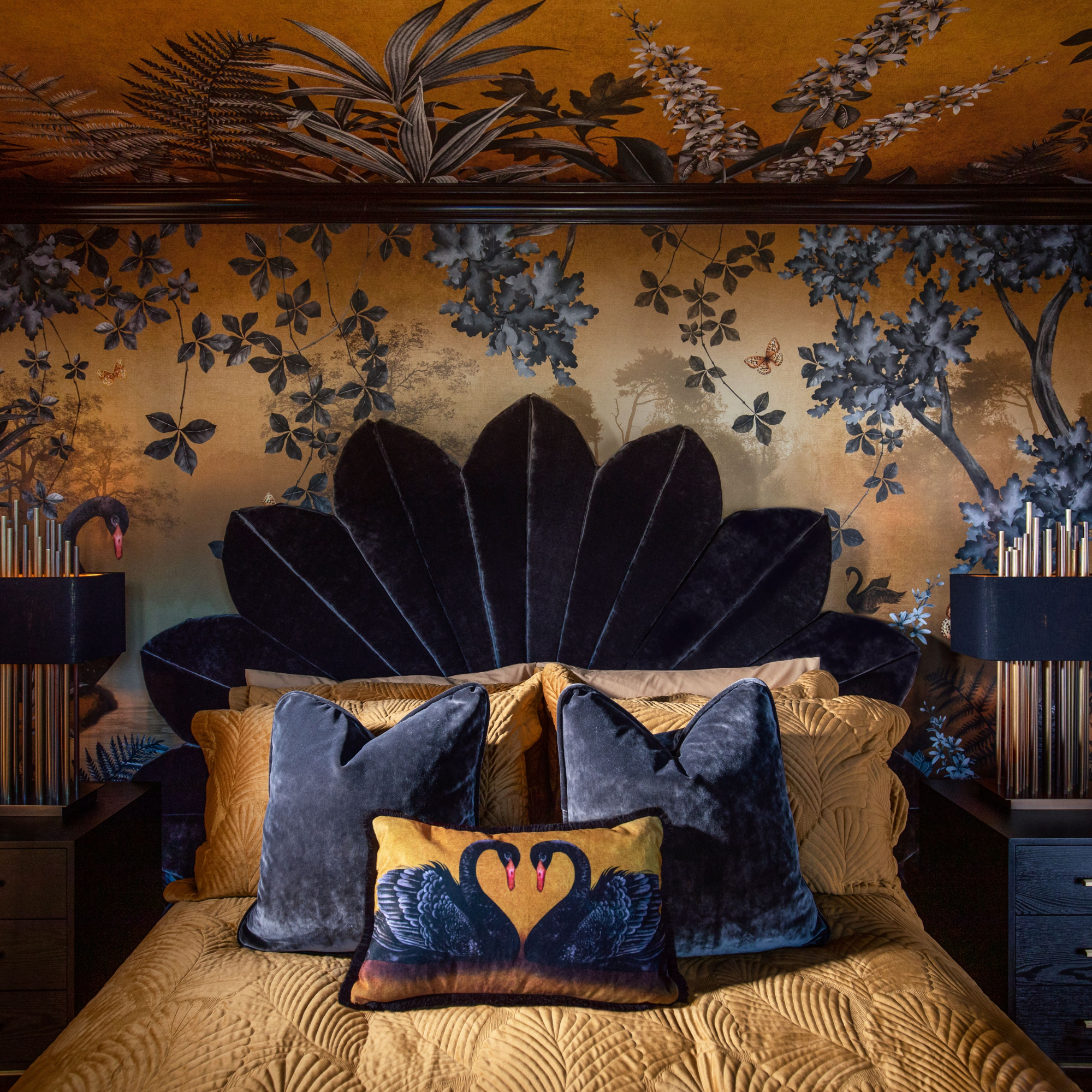 Gold and dark blue wall and ceiling mural in bedroom, with matching headboard and bedding design