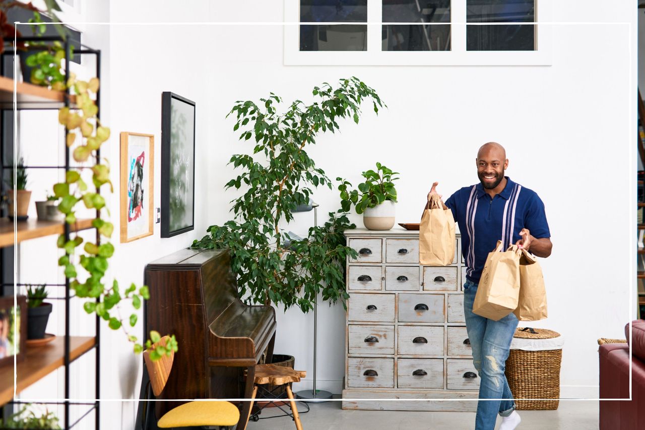 Man carrying takeaway food in brown paper bags