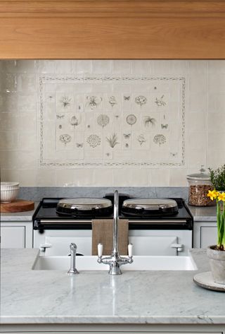 a traditional kitchen with illustrative backsplash tiles and large range cooker