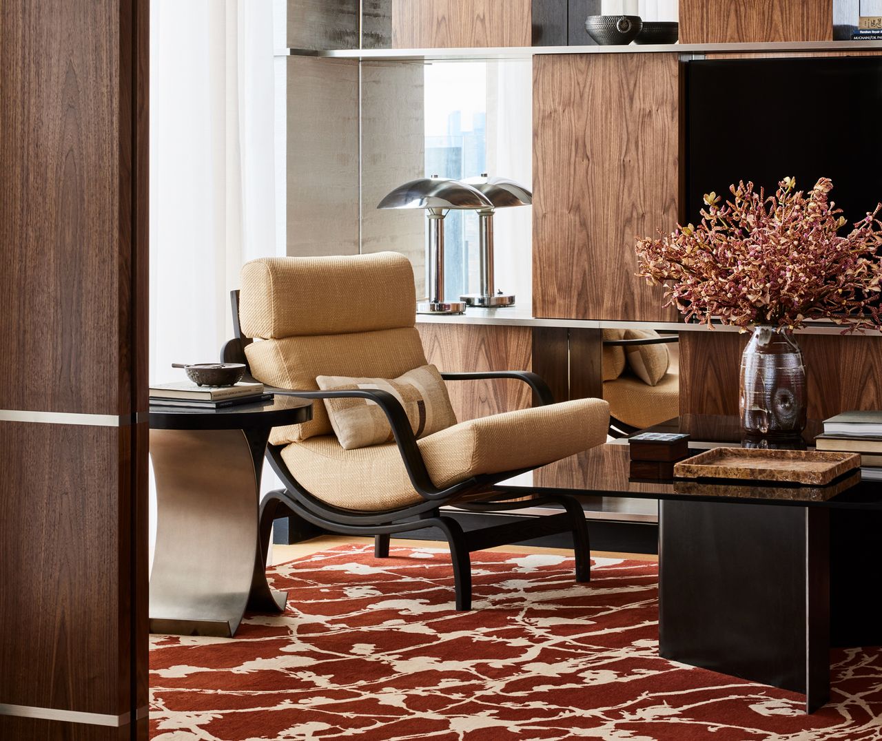 a tv room with mirror paneled walls