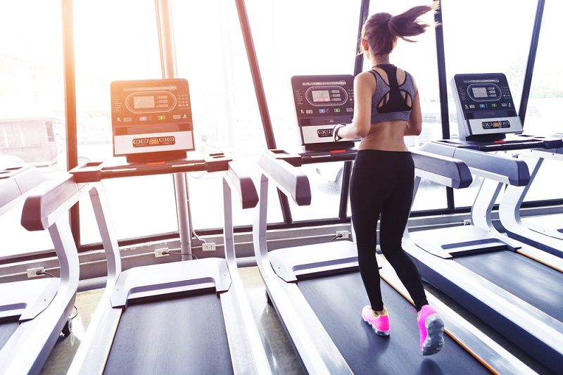 A woman exercising on a treadmill. 