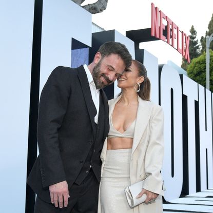 Jennifer Lopez and Ben Affleck kiss on a red carpet