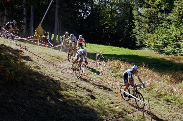 Men's elite field on a technical downhill section.