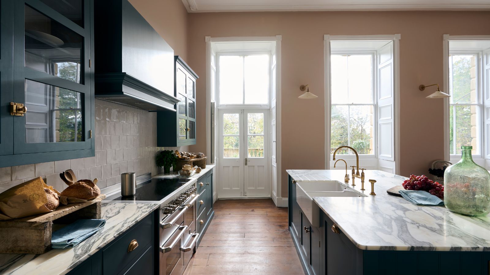 shaker kitchen with plaster pink walls and dark blue cabinets