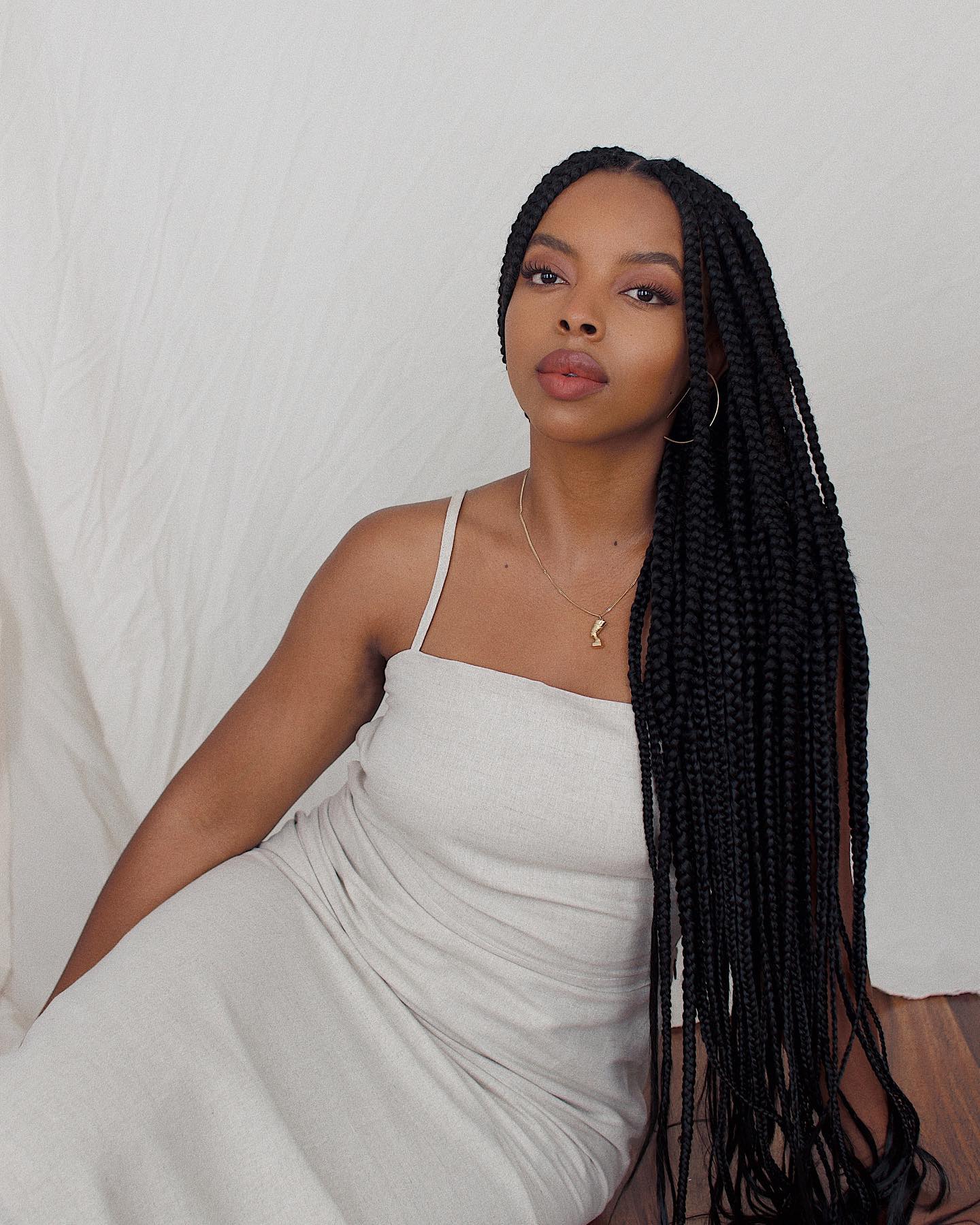 Aysha Sow with long, medium braids wearing an Olette dress