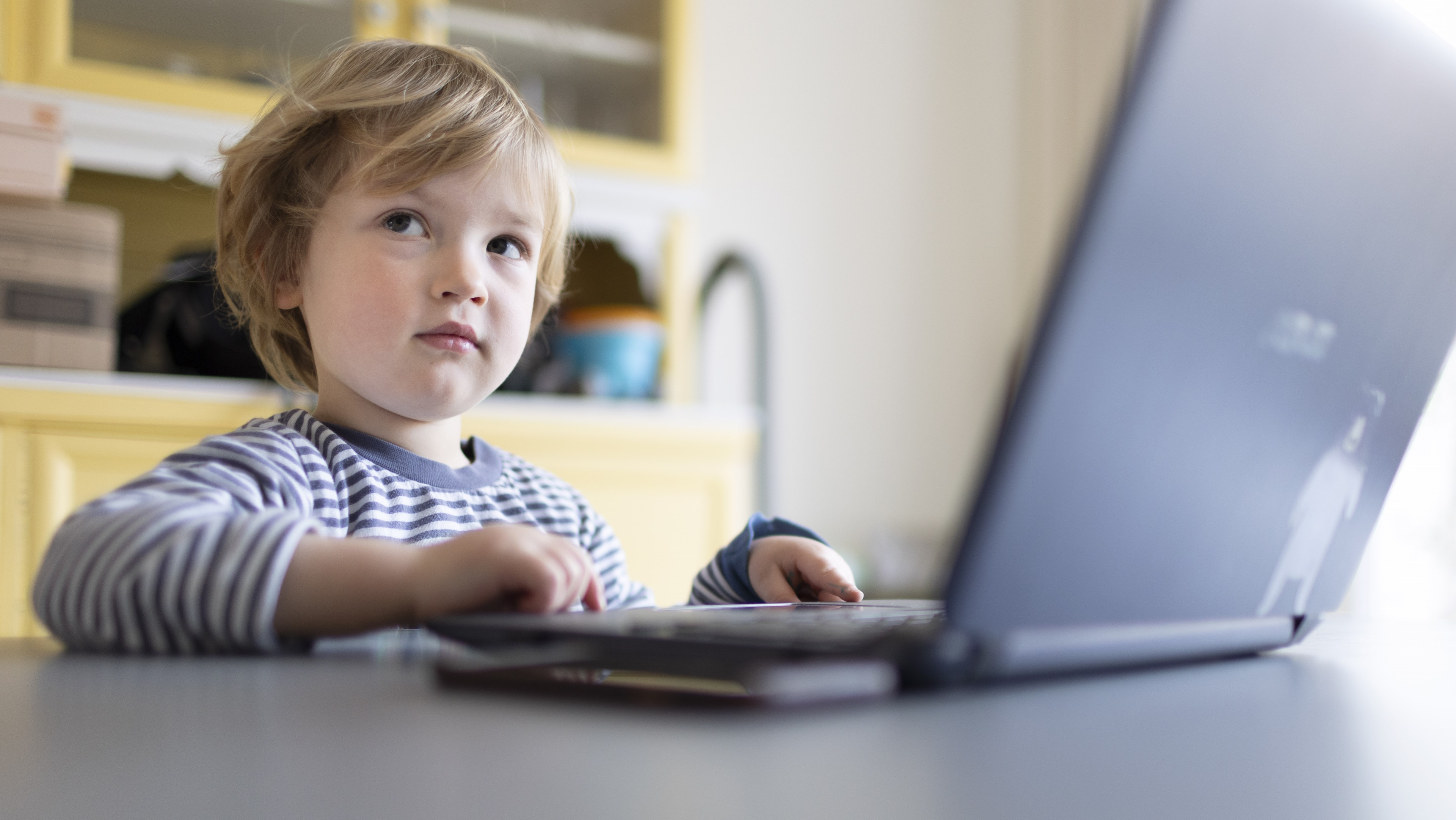 BONN, GERMANY - MARCH 20: In this photo illustration Child playing at a laptop on March 20, 2022 in Bonn, Germany. (Photo Illustration by Ute Grabowsky/Getty Images)