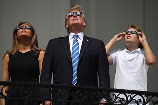 President Trump, Melania and Barron observe the solar eclipse of Aug. 21, 2017, with glasses.