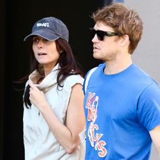 Mary Beth Barone wearing cobalt leggings, walking with Joe Alwyn in NYC