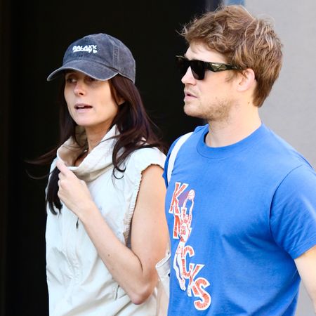 Mary Beth Barone wearing cobalt leggings, walking with Joe Alwyn in NYC